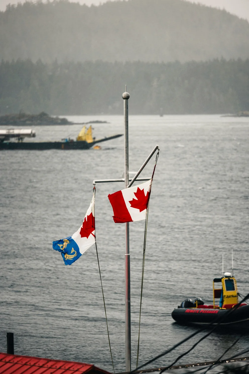 Flags and working boats across Tofino harbour